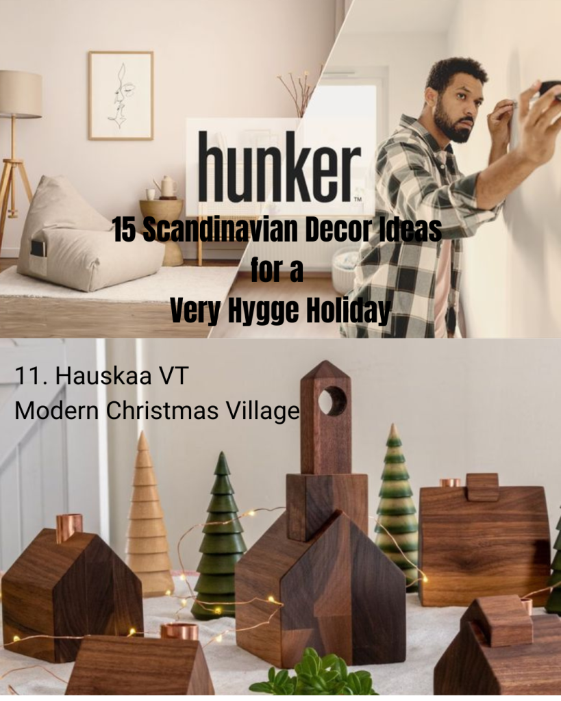 Hunker feature highlighting Hauskaa. The image includes the Hunker logo over a split background showing a cozy Scandinavian-style living room and a man decorating a wall. Text reads: ‘15 Scandinavian Decor Ideas for a Very Hygge Holiday.’ Below, a photo of wooden holiday village décor appears with the caption: ‘11. Hauskaa VT Modern Christmas Village.’