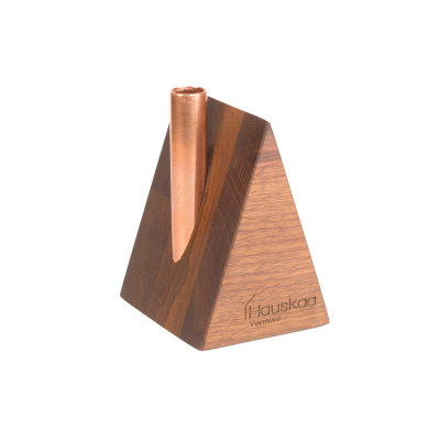A mini wooden a-frame house candlestick holder with a copper chimney.