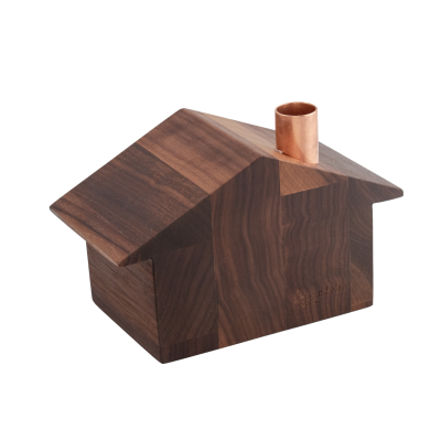 Wooden house with a slanted roof and a copper chimney