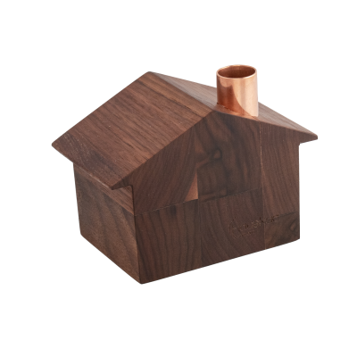 Wooden house with a slanted roof and a copper chimney