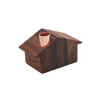 Wooden house with a slanted roof and a copper chimney
