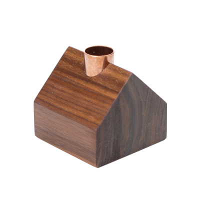 A tiny little cottage candlestick holder with a copper chimney.