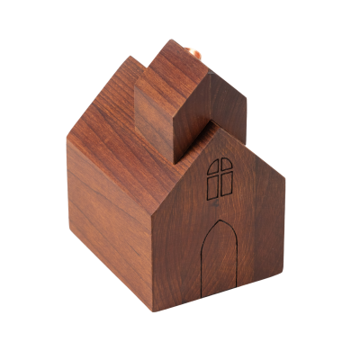 A little wooden church candlestick holder with a door and a window.