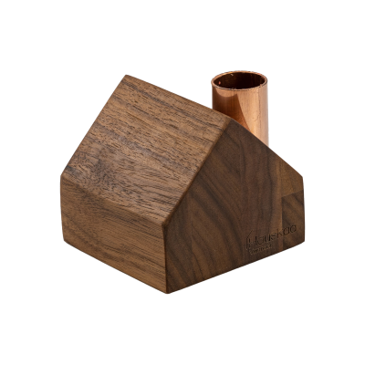 A tiny wooden cottage with a copper chimney.