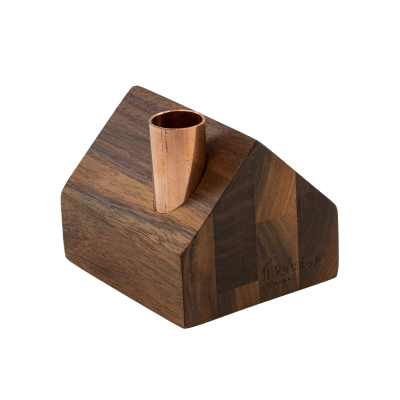 A tiny wooden farmhouse with a copper chimney.