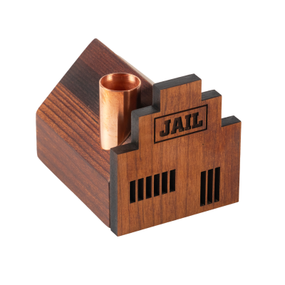 A little jail house wooden candlestick holder with a copper chimney.