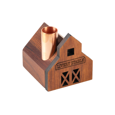 A little livery stable wooden candlestick holder with a copper chimney.