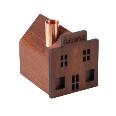 A little mercantile wooden candlestick holder with a copper chimney.