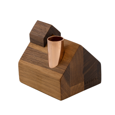 A small wooden schoolhouse with a copper chimney.