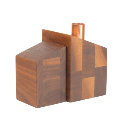 A little wooden split-level house candlestick holder with a copper chimney.