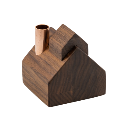 A small wooden sugarhouse with a copper chimney.