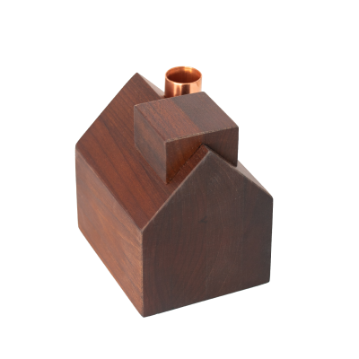 A beautiful wooden building with a copper chimney